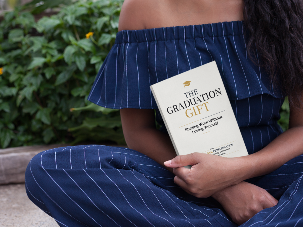 Graduate holding The Graduation Gift book
